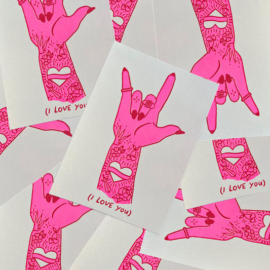 Pink and Red risograph print of an illustration of a patchwork tattooed hand signing "I love you" in ASL with translation below.