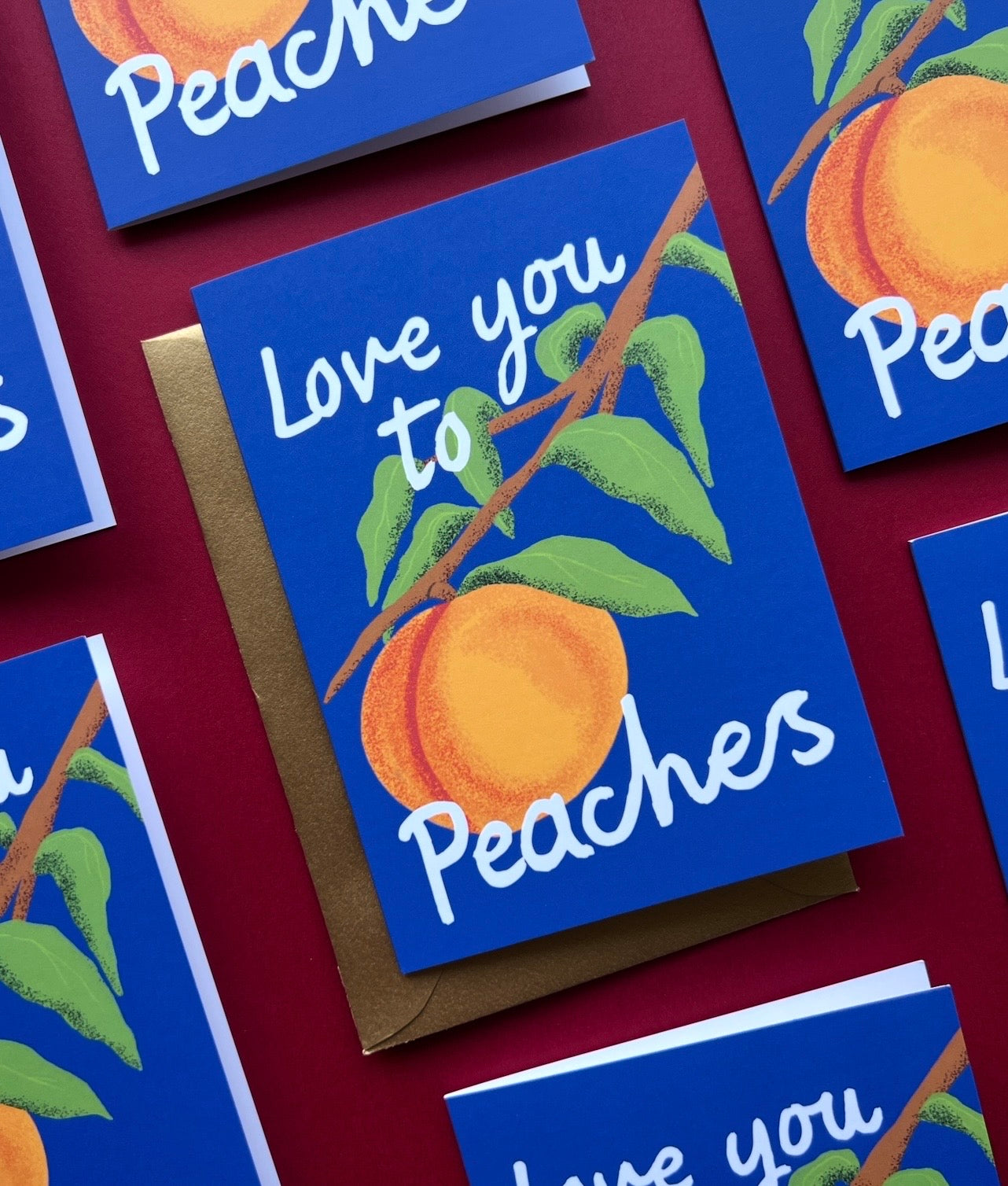 Greeting card with 'Love you to peaches' text and peach illustration on a blue background