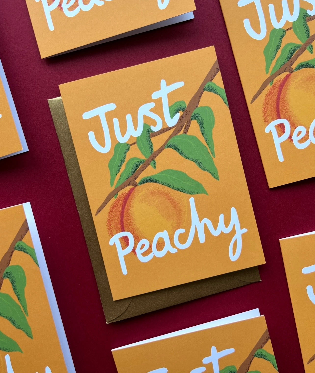 Greeting card with 'Just Peachy' text and peach illustration on a yellow background