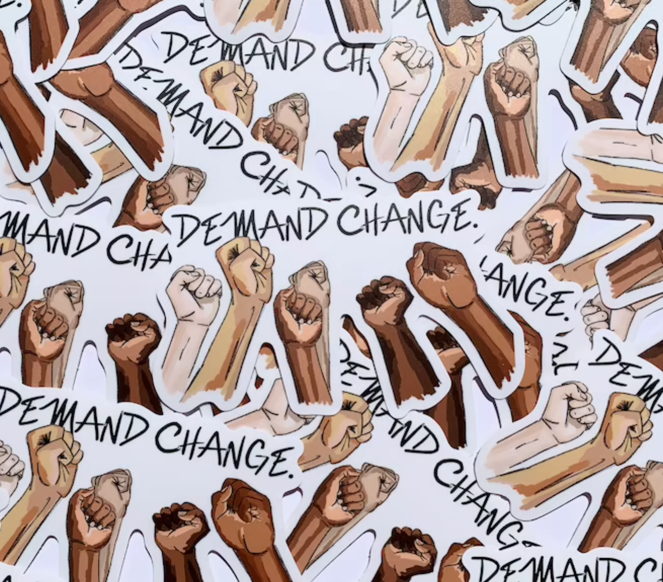 Illustrated sticker that says demand change with fists raised.