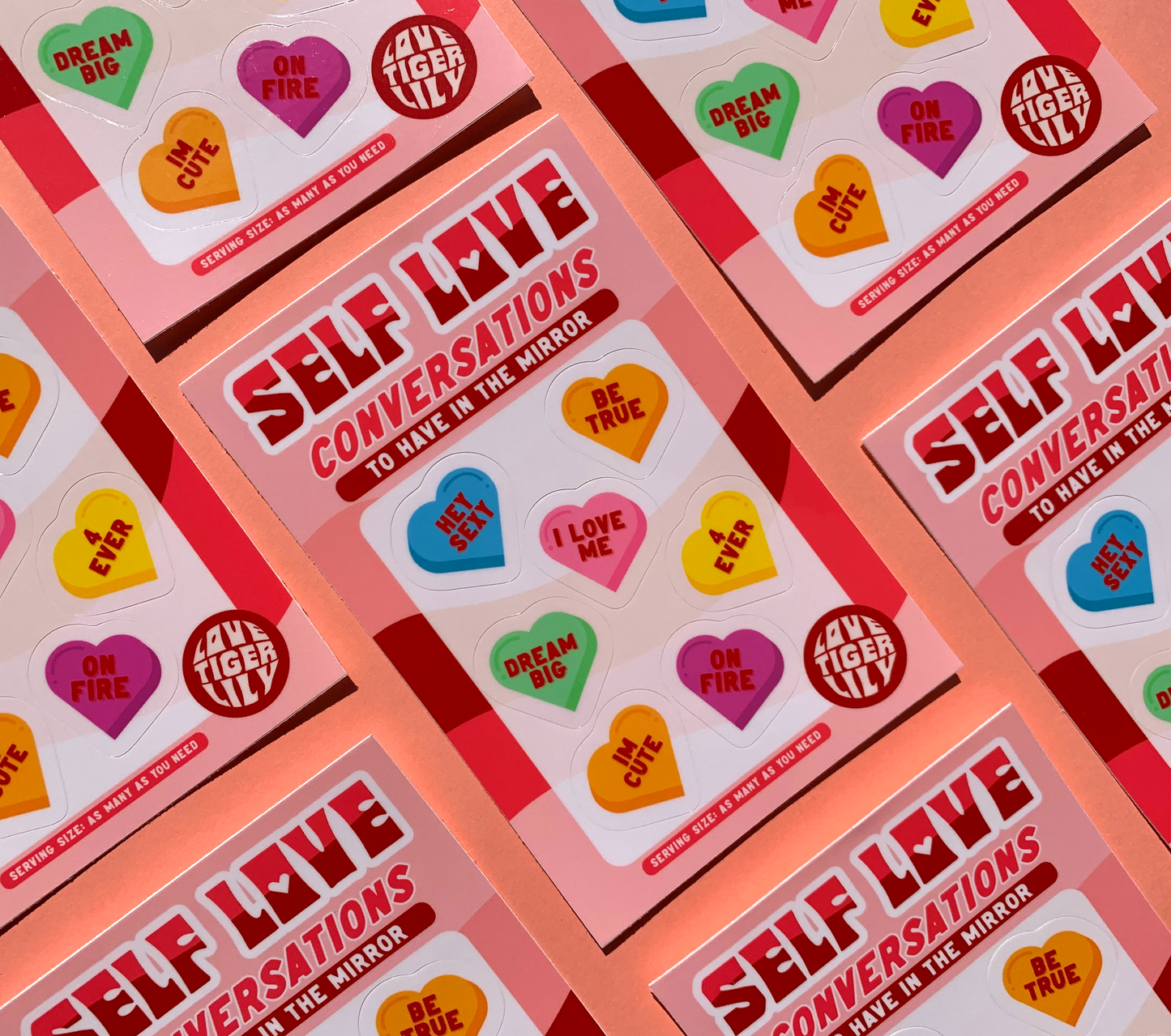 Self Love Conversations to have in the mirror sticker sheet that resembles a pink and red box of sweets. Serving size: as many as you need. Each heart is a waterproof sticker with sentiments such as "be true" "hey sexy" "I love me" "4 ever" "dream big" "on fire" and "I'm cute.